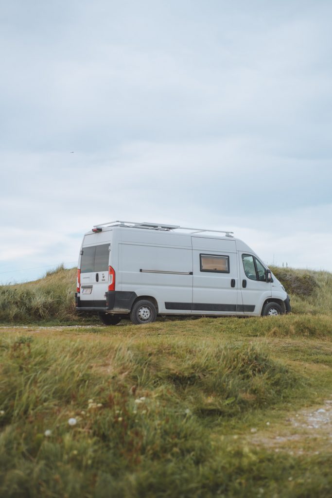 white camper van parked in a grassy area
