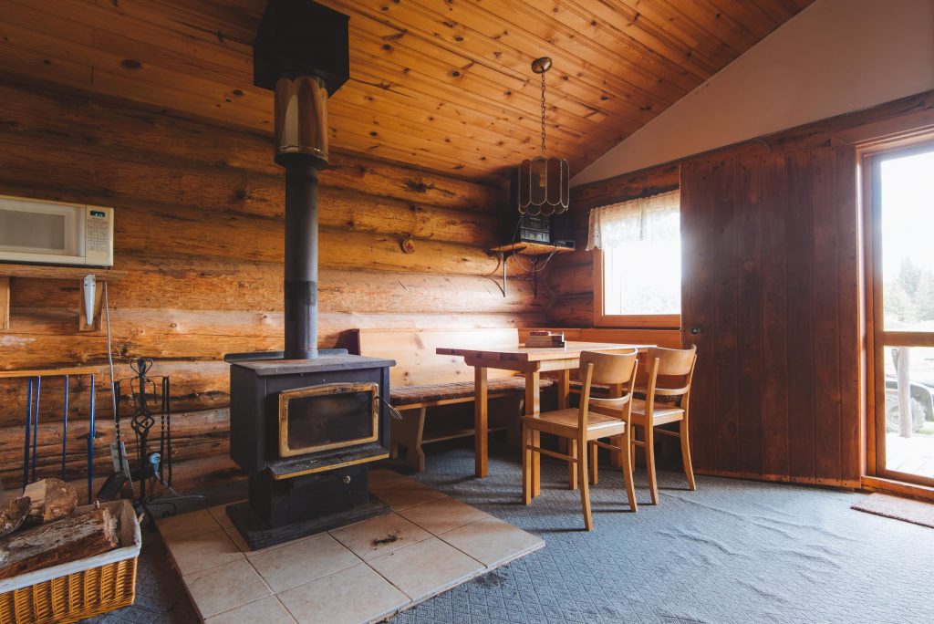 interior of the cabin, dining table with chairs and wood stove