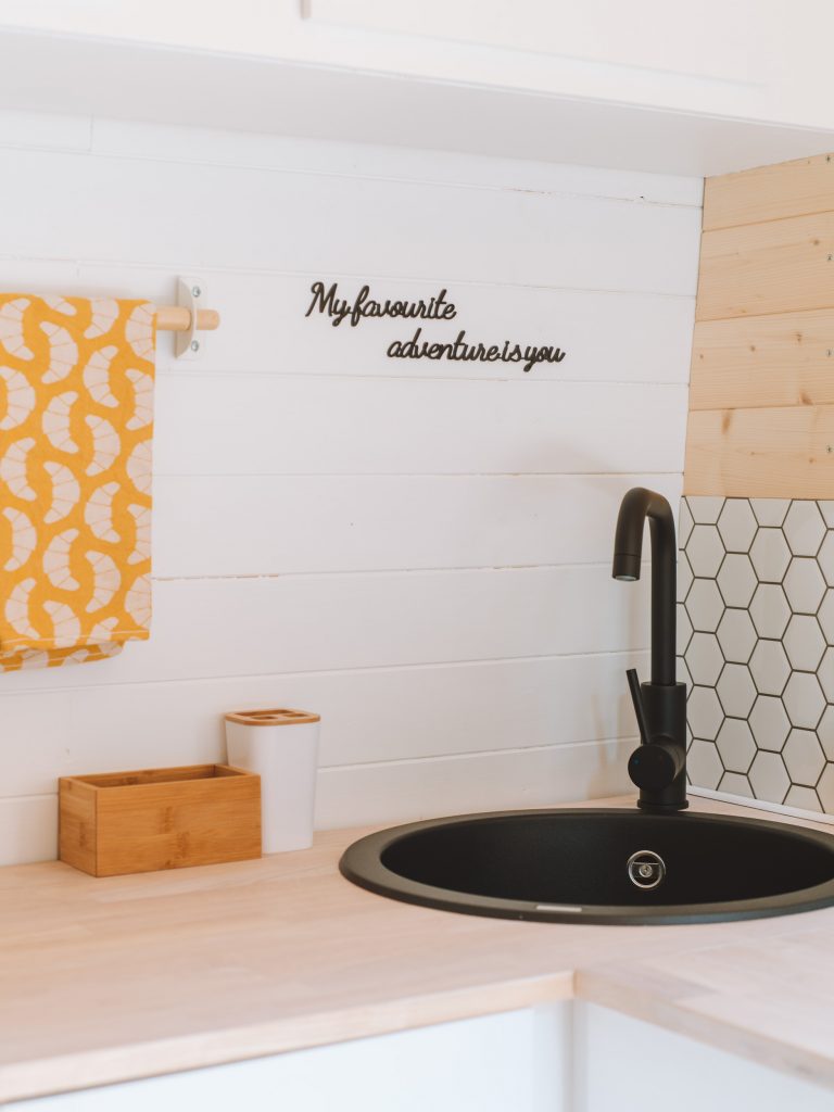 black sink and faucet in our camper kitchen