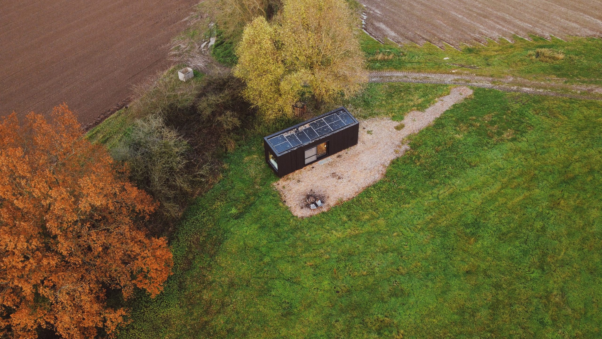 view from above of the slow cabin and fields surrounding it