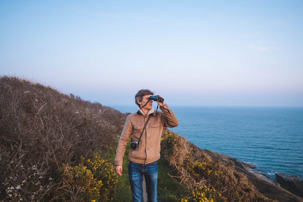 florian looking at the ocean with binoculars