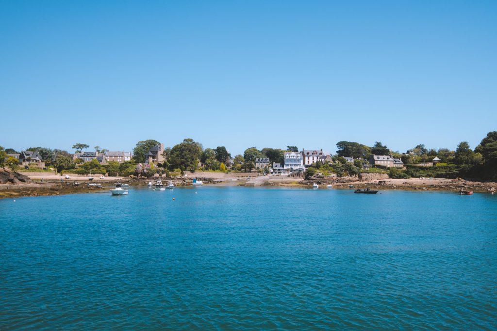 view of the ocean with houses on an island in the background