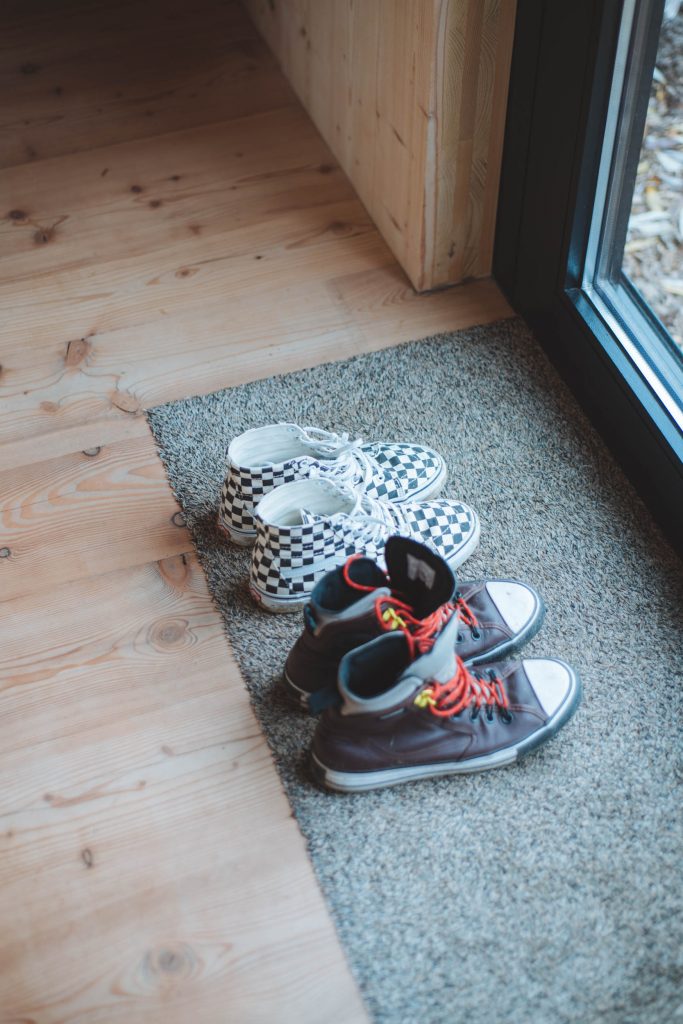 two pairs of shoes waiting by the door