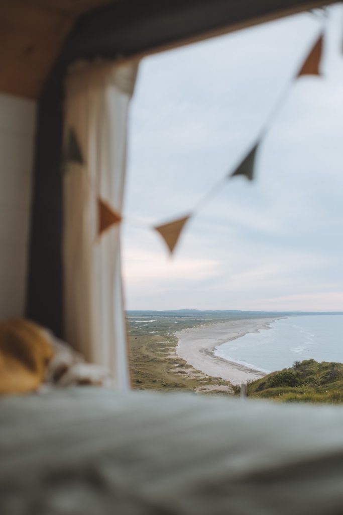 view from the back of our camper overlooking a cliff near the ocean