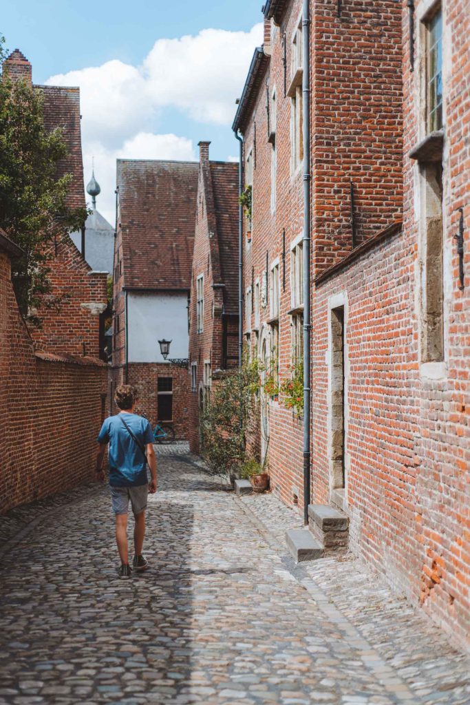 florian walking on the cobbled streets between red brick houses