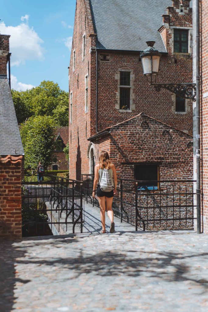 kelly walking over a bridge in the great beguinage of leuven