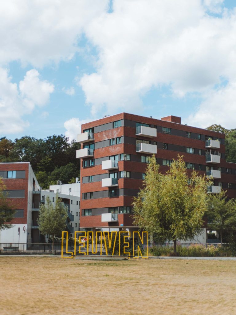 sign of leuven with apartments buildings in the background