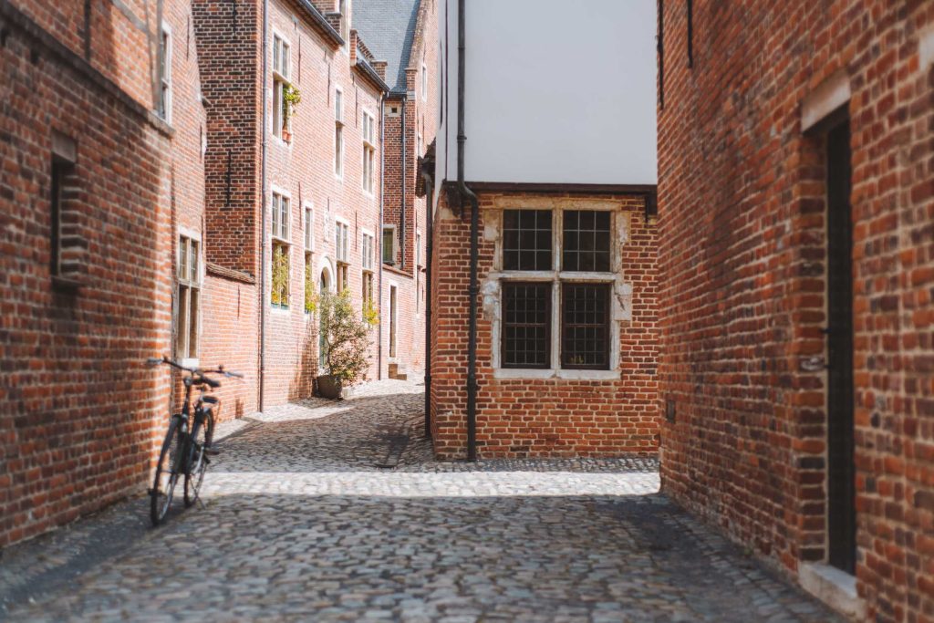 bike and brick houses in the street of the great beguinage in leuven