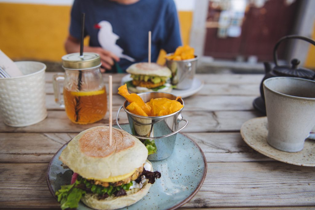 eating a vegetarian hamburger and chips at avocado healthy food