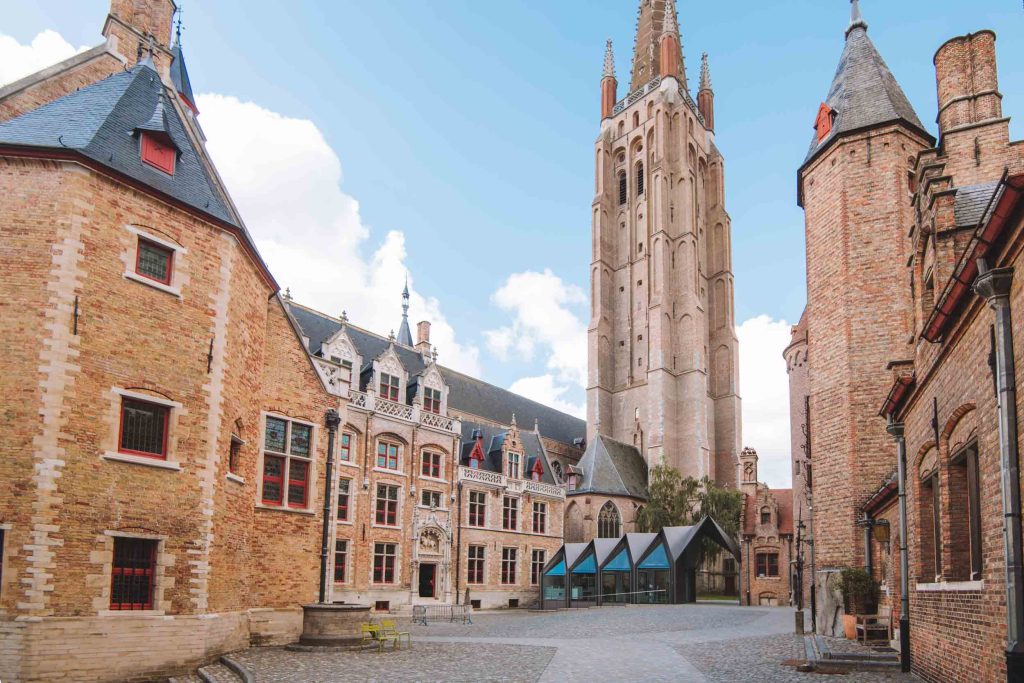 the gruuthuse Palace inner courtyard with modern pavilion and the church of our lady in the back