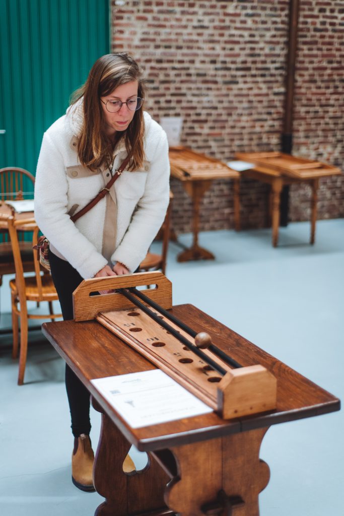 kelly playing old folk game in the hopmuseum