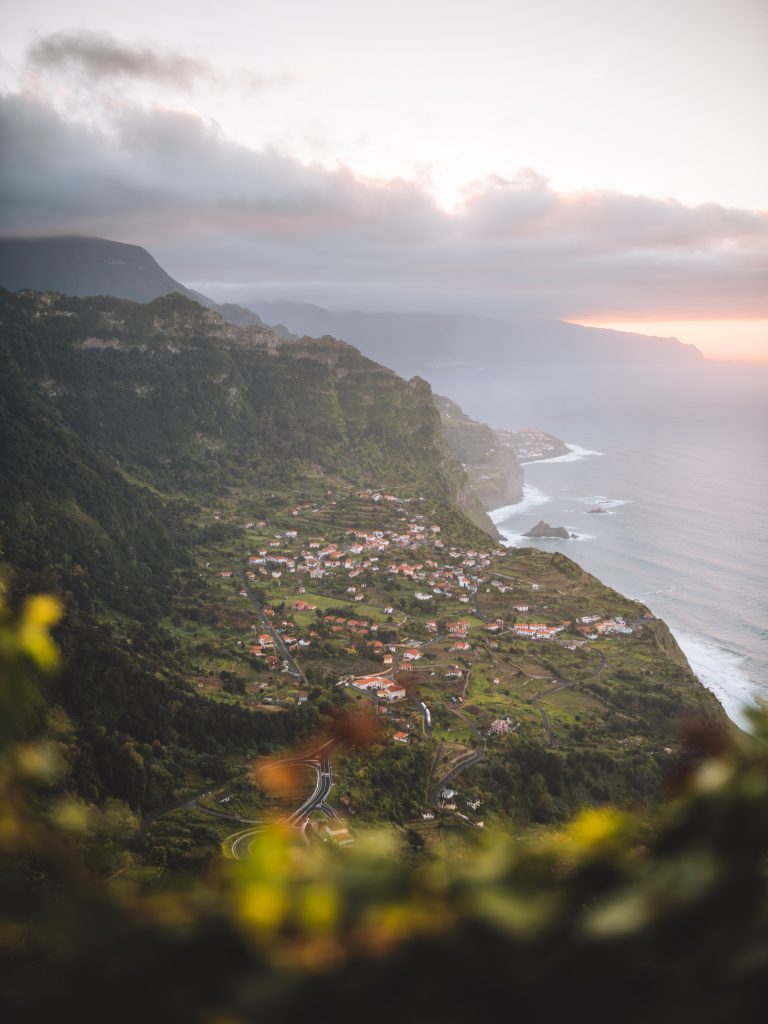 view of white houses with orange roofs and the road in madeira