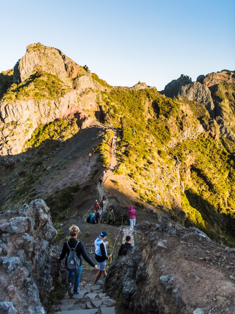 people hiking the pico de Arieiro trail in madeira early in the morning