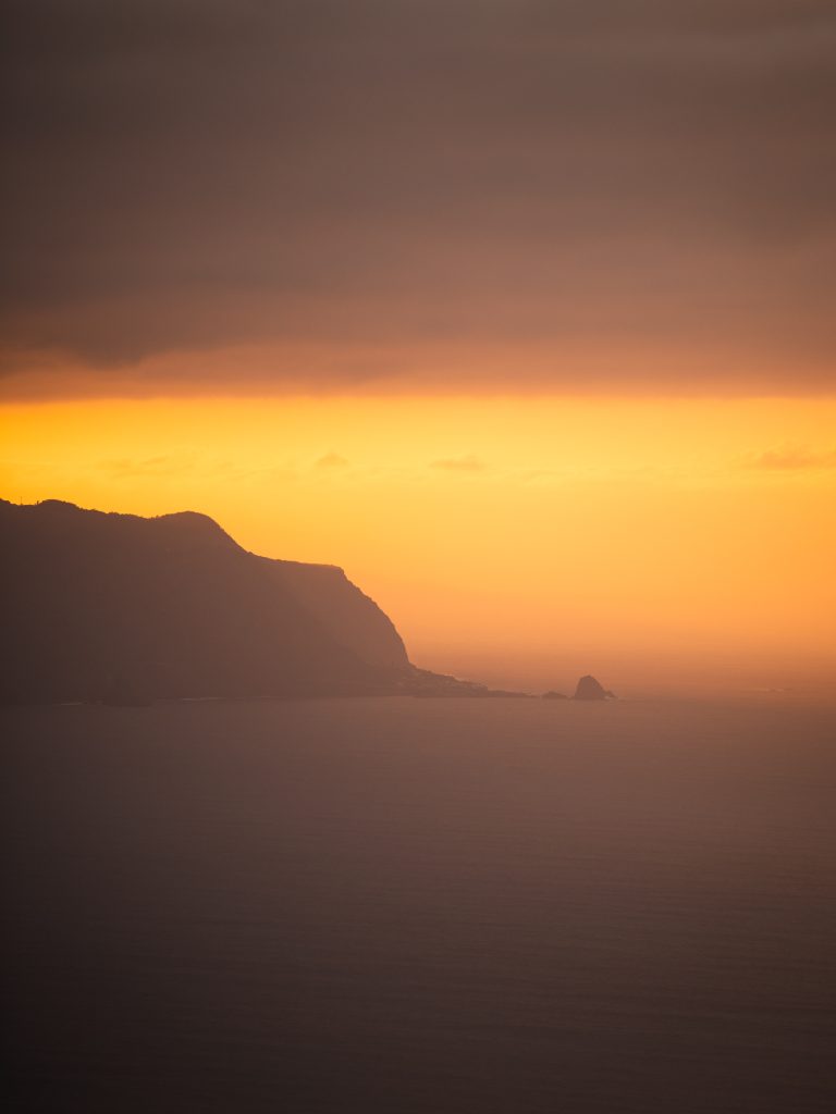 orange sunset with cliffs and the ocean