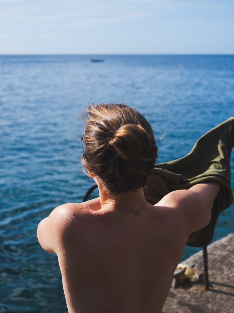 kelly putting on her t-shirt after taking a swim in the ocean