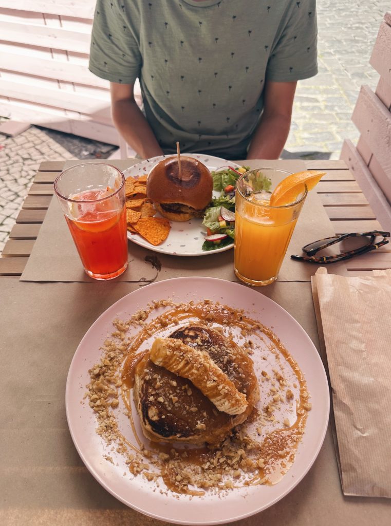 banana pancakes and a hamburger for lunch with two fresh juices