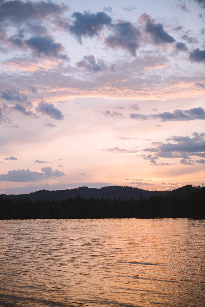 pink purple sky reflecting in the lake during sunset